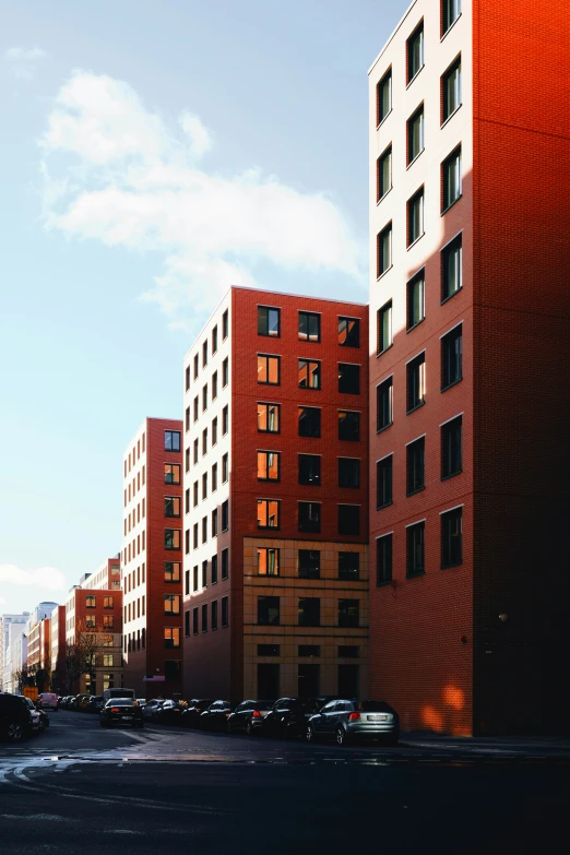 tall brick buildings line the street in the city