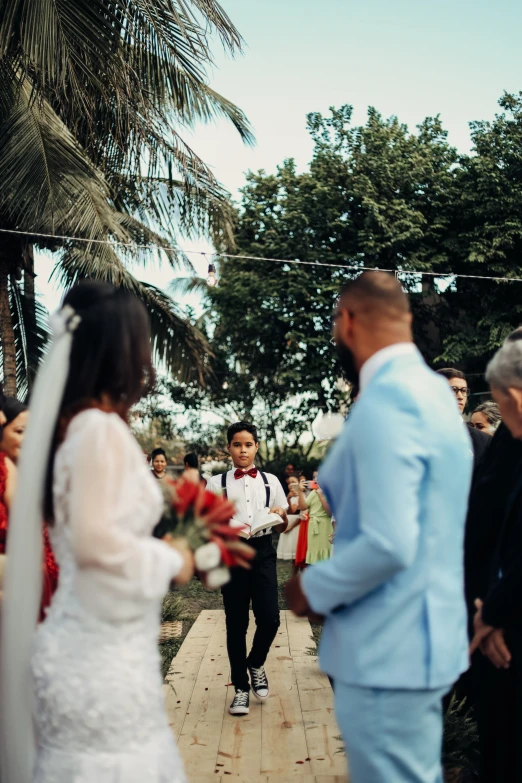 a wedding ceremony in front of several people