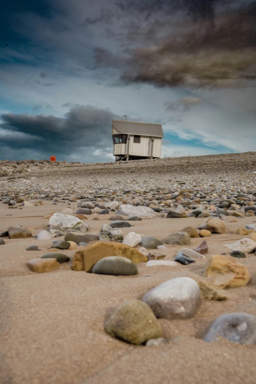 there is a shed near the rocks on the beach