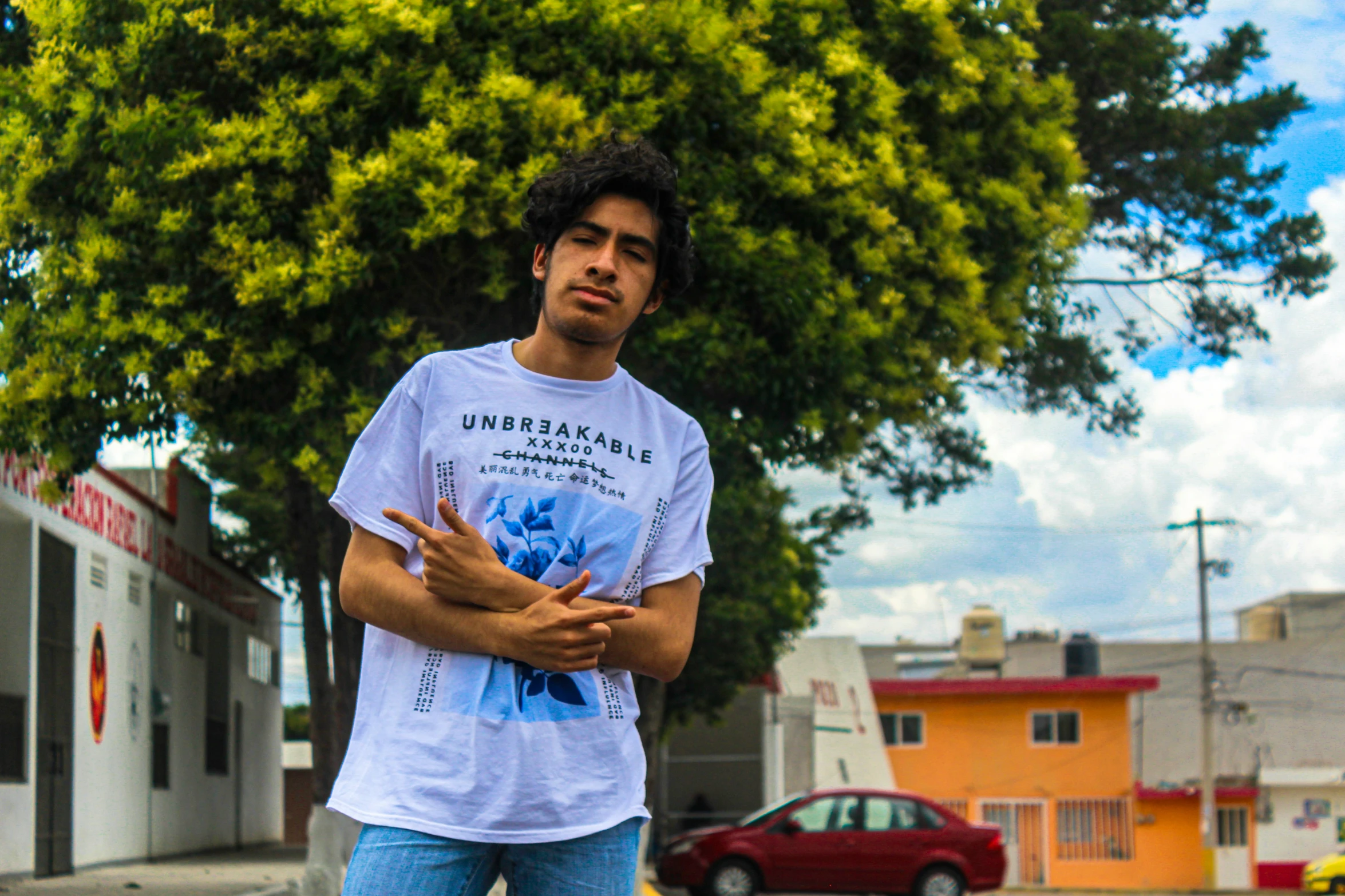 a man standing on a skateboard next to a tall tree