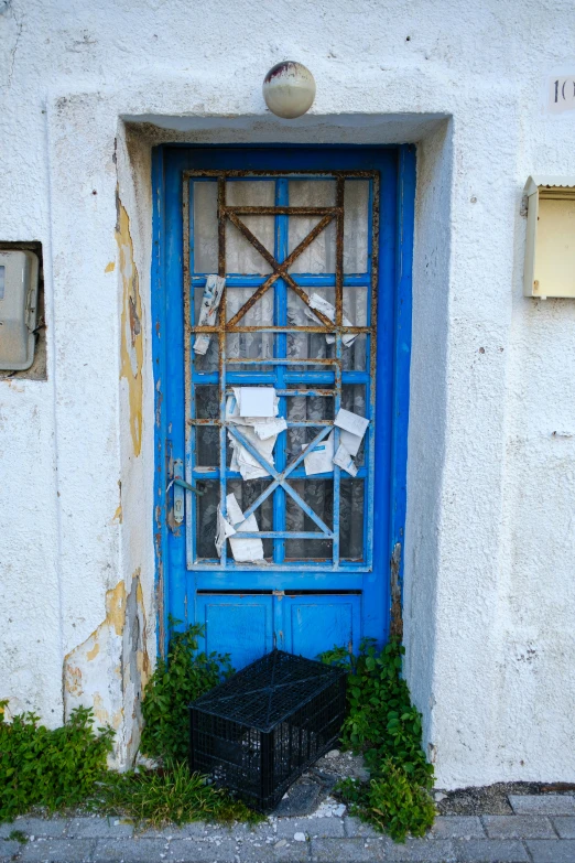 a blue and white door sits next to a window