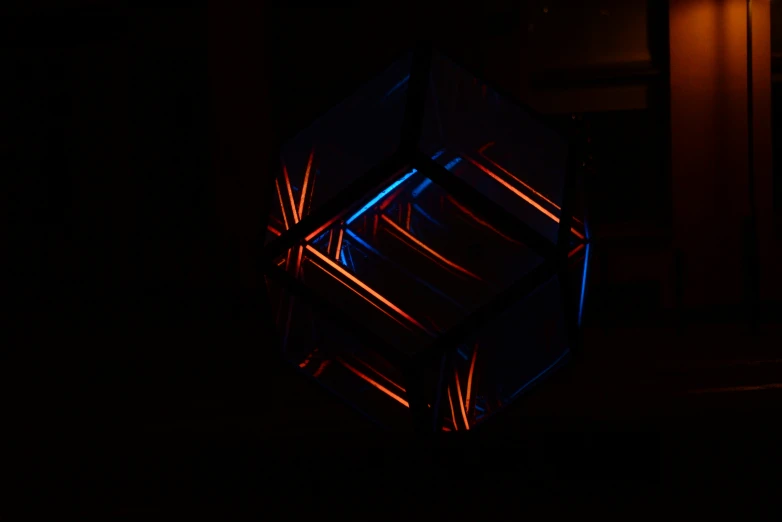 a multicolored cube made of wire and light