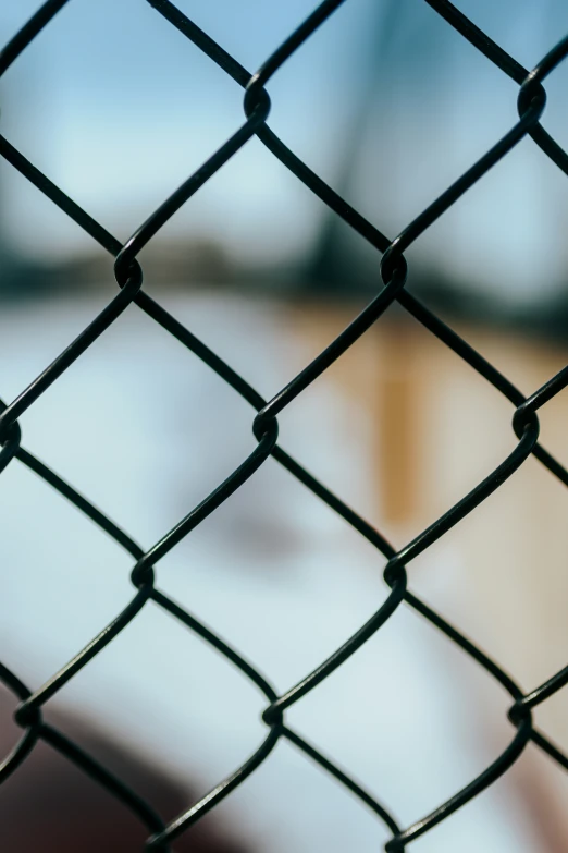a chain link fence that is in front of some kind of blurry background
