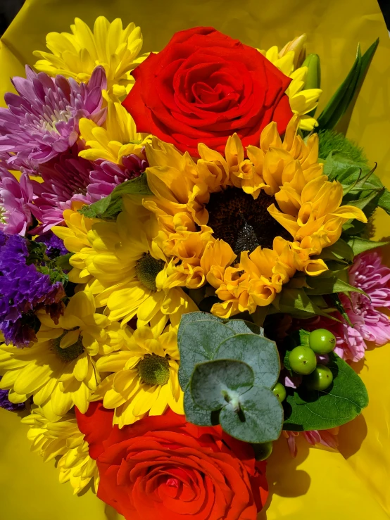 flowers, berries and leaves on a yellow sheet