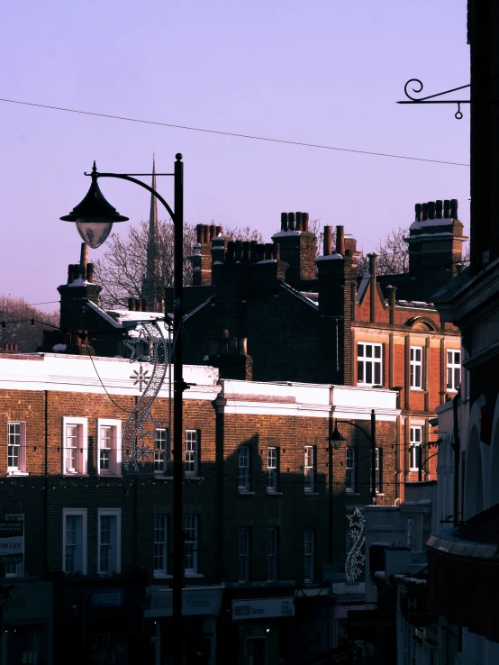 a dark image of some buildings in the distance