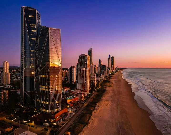 a city skyline with tall buildings and an ocean