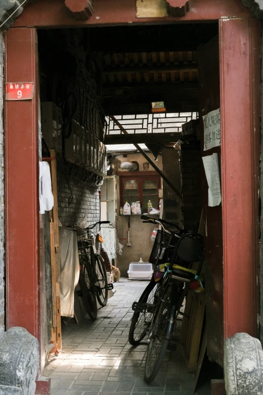 two bikes parked in an open doorway of a building