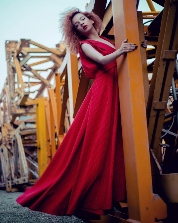 a woman poses on the side of a building