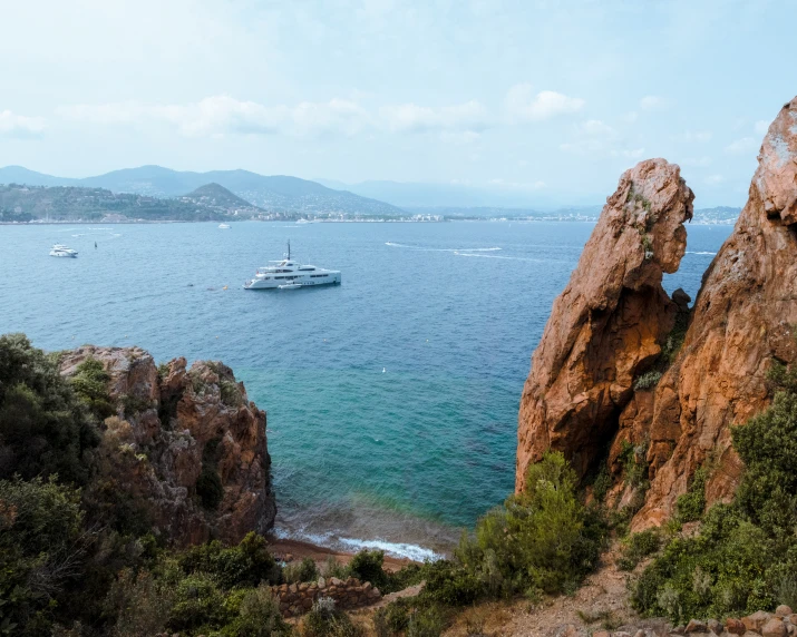 a boat on the ocean near the rocks