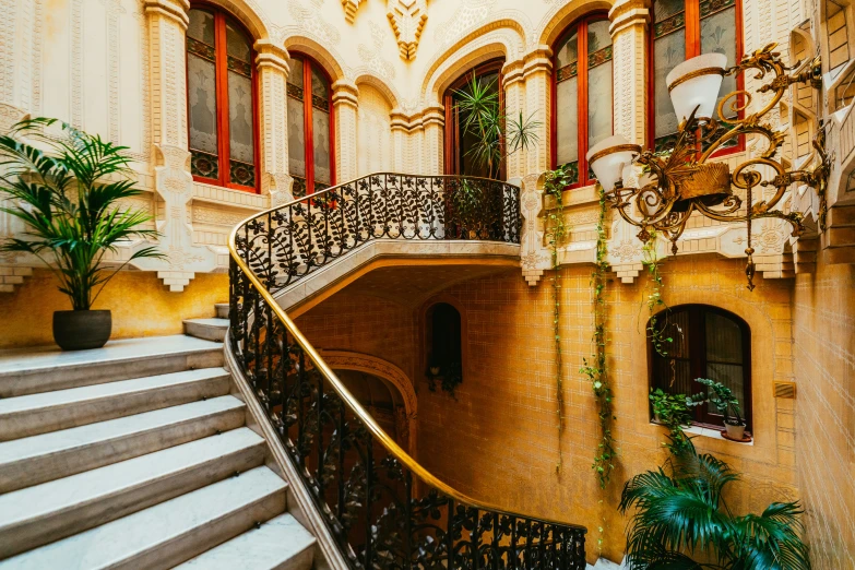 an ornate building has wrought iron railings and red and white trim