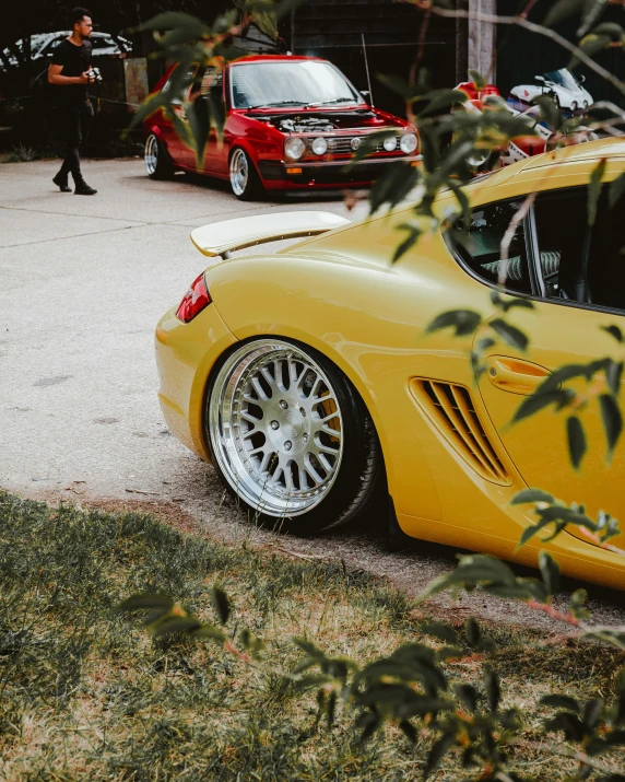 a yellow sports car sitting in a parking lot