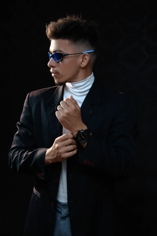 a man wearing a jacket and a white shirt with a watch