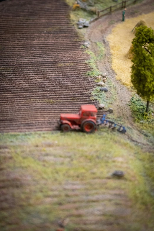 a crop circle is being worked by a man driving a tractor