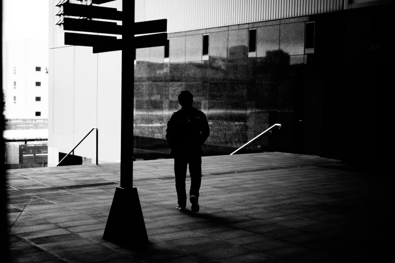 a lone man is standing at the corner