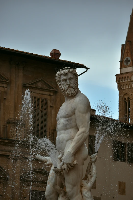 a statue of a man is surrounded by water fountain