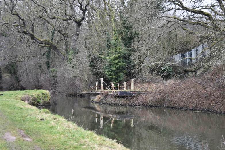 a bridge with people standing on it over a river