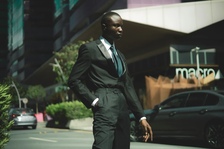 man in suit standing in the middle of a city street
