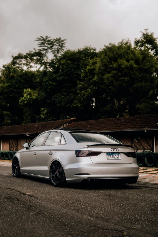 a white car sitting on the side of a road