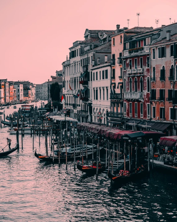 two gondolas in the foreground of an old city street