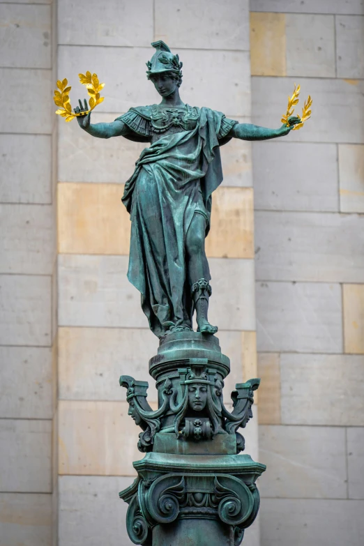 a statue of liberty holding hands over two yellow flowers