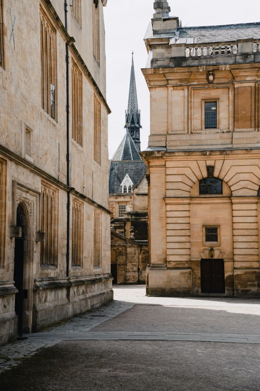 a row of buildings with a very old style church tower