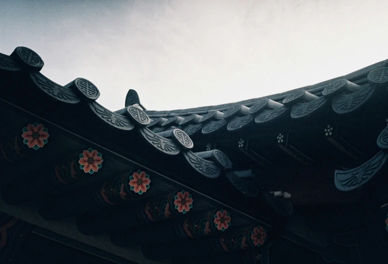 a close up of a chinese roof with sky background