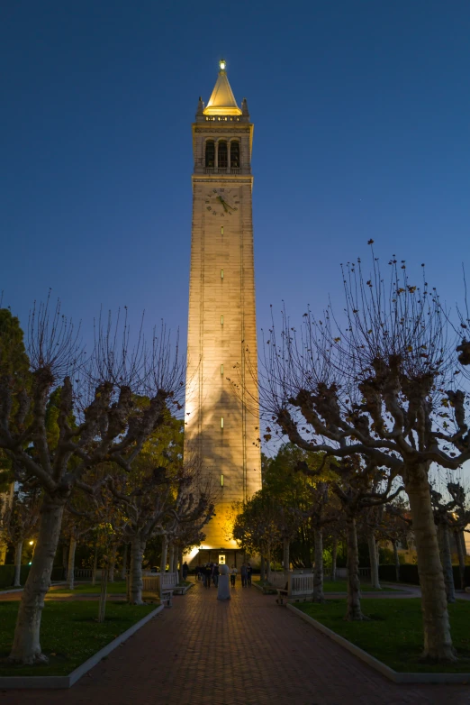 people are standing in front of a clock tower