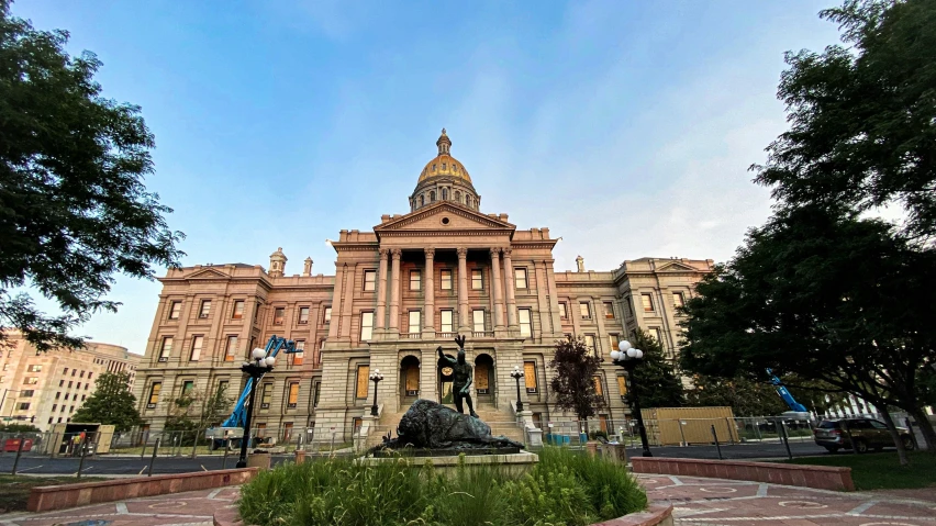 a building with a clock tower and fountain