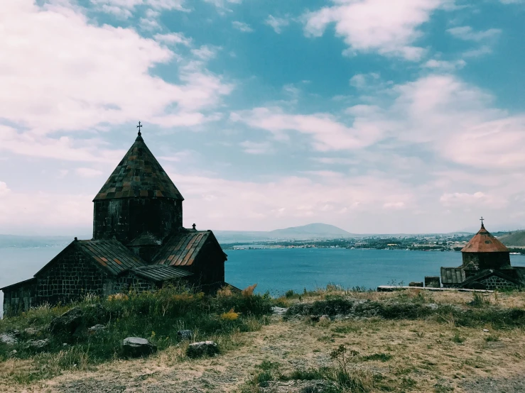 an old church with a water way in the background