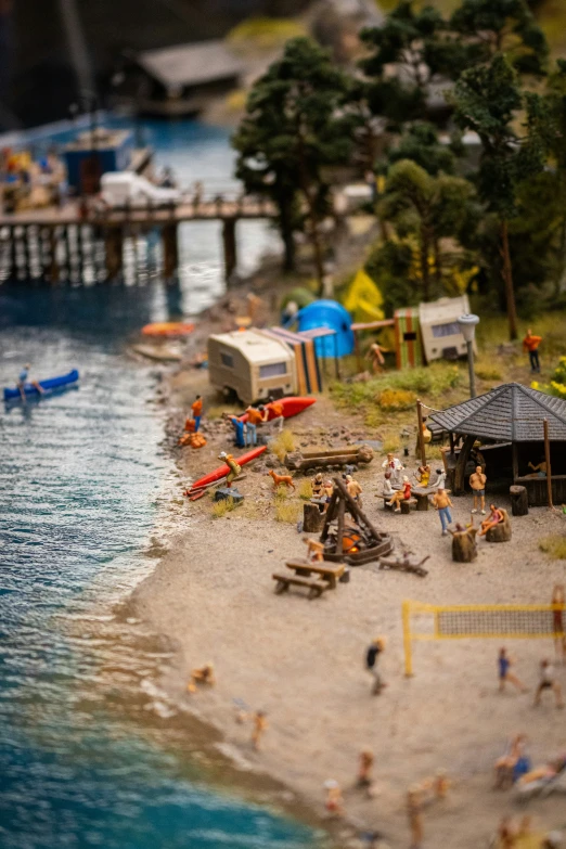 the model of a beach with boats and people on it