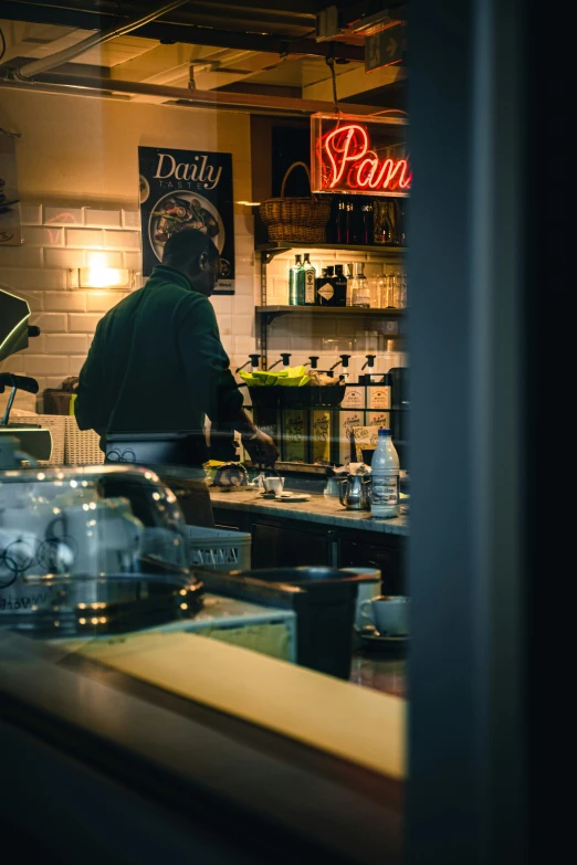 a man standing at a counter near some food