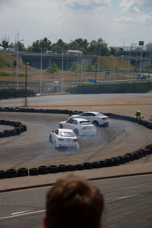 two race cars driving on top of an intersection