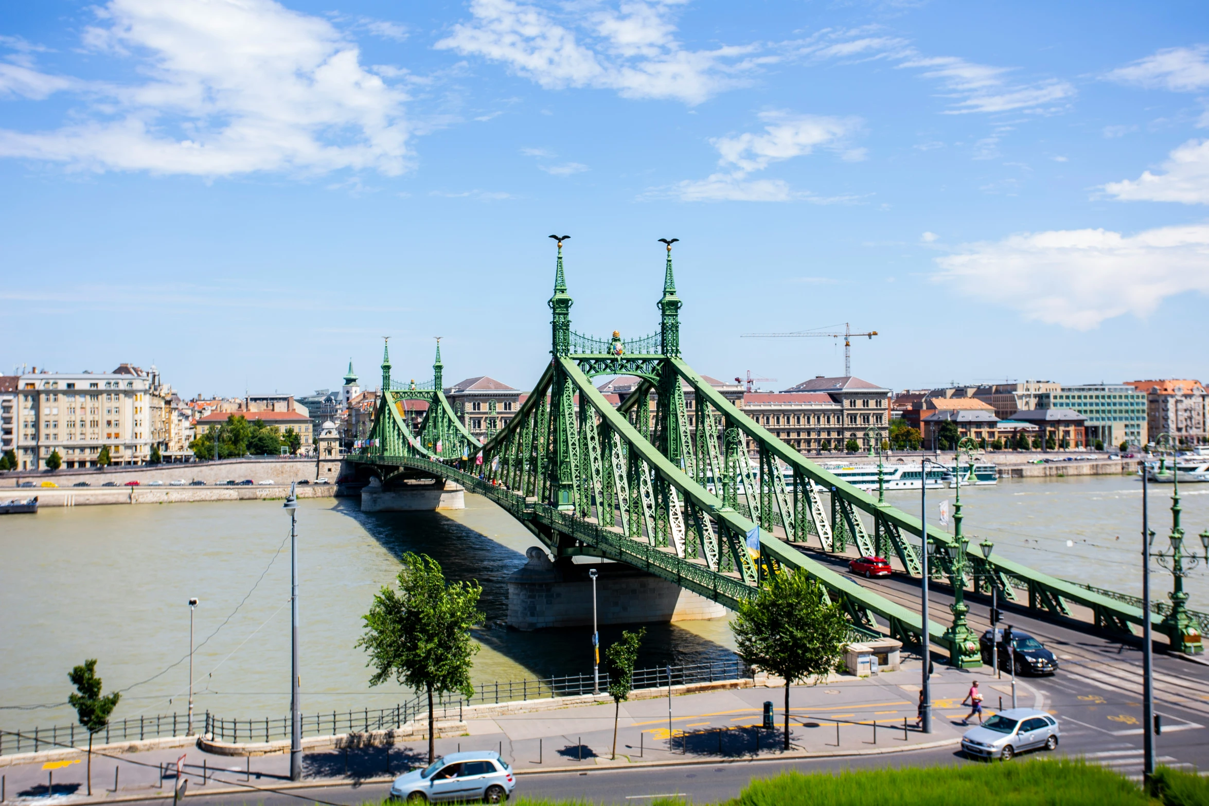 the large green bridge crosses a wide river