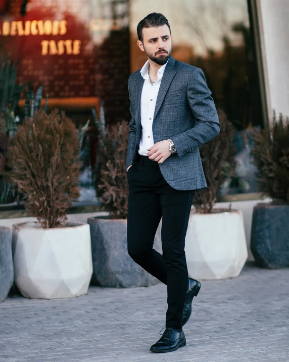 man in suit and tie standing outside a business