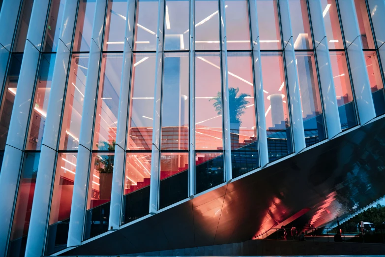 a large building has windows reflecting buildings on the outside