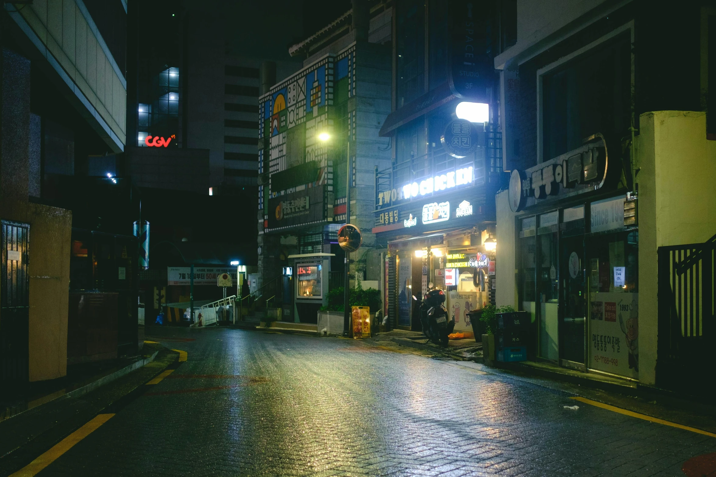 a small store on the side of a dark street