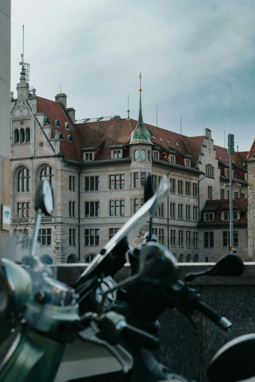 motor scooter parked in front of ornate buildings in the city