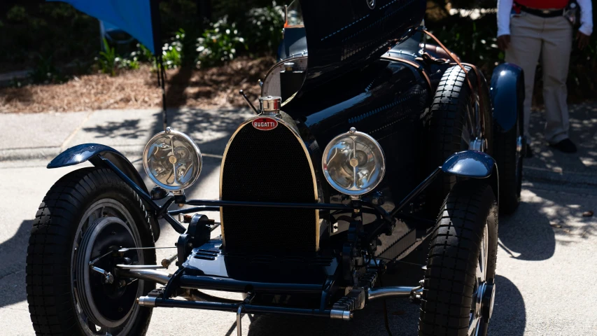 the front end of an old car with chrome and leather