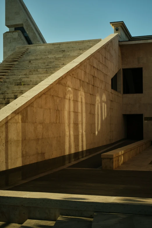 a building with several windows that are shadows on the concrete