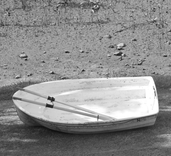 a small boat is on the beach with poles