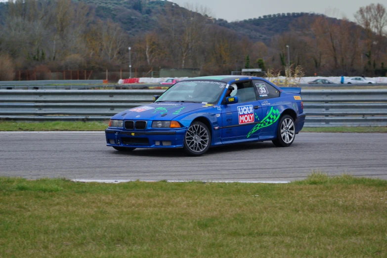 an automobile racing track with a blue car on it