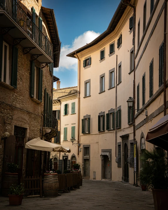 an empty street is lined with old buildings