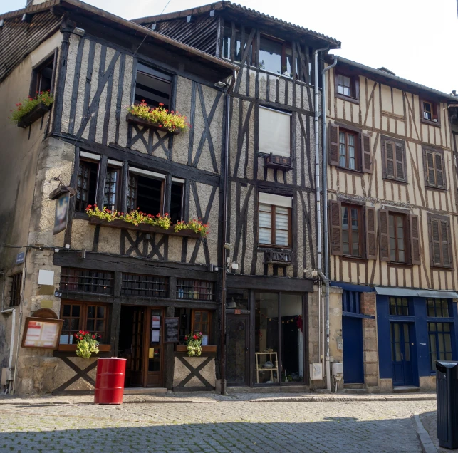 a building with flowers on its windows in an old european town