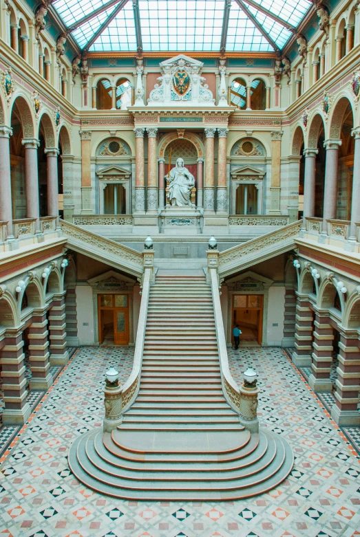 a large clock tower on top of a building with a lot of stairs