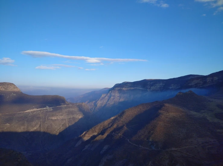 there is a bird that is flying over a canyon