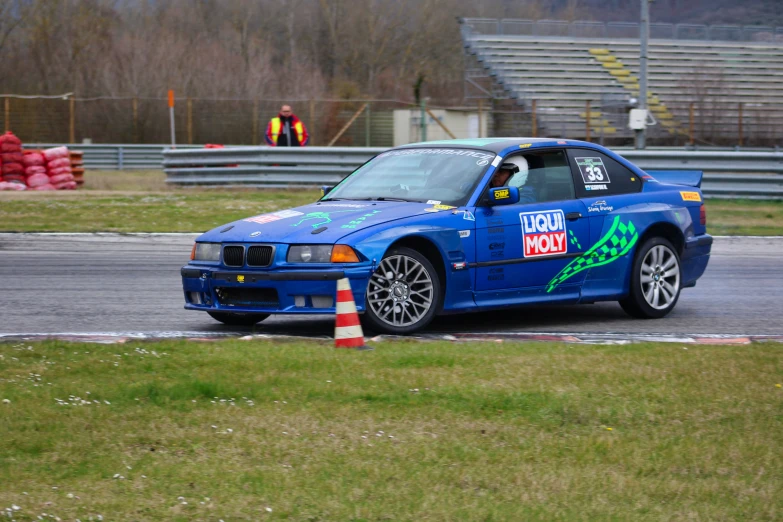 a blue bmw with a green arrow painted on the side