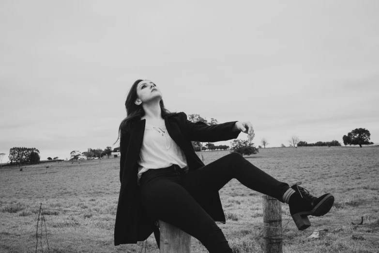 a young woman poses for a black and white po