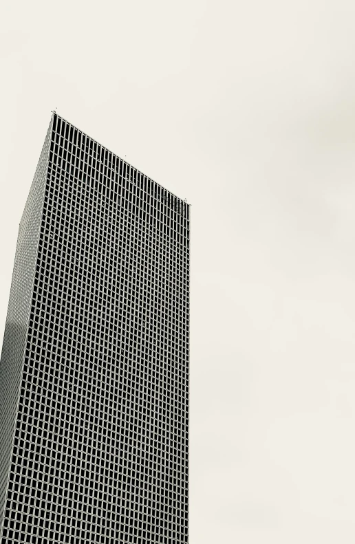 an airplane flying through the air near a building