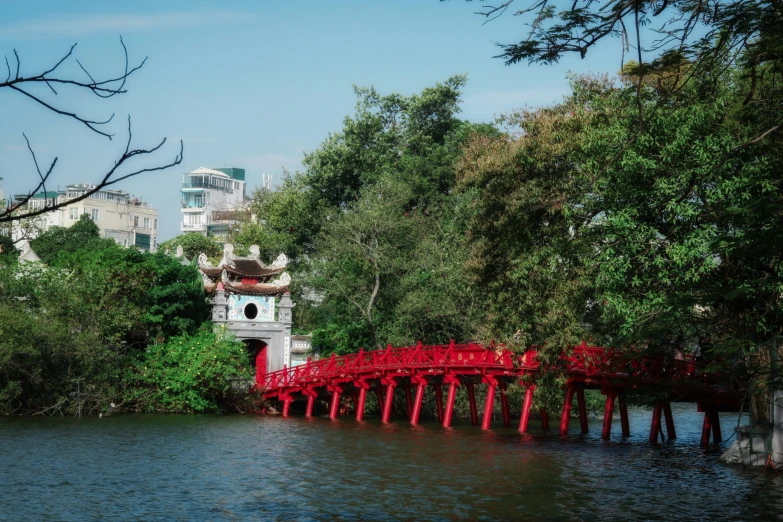 red bridge going over the water with many people on it