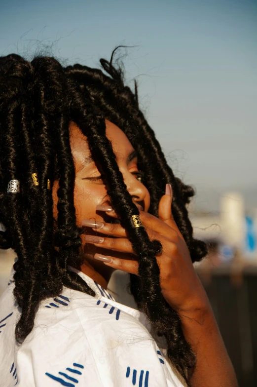 a woman with dreadlocks talking on her cell phone
